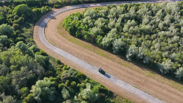 Car Driving on a Curved Track at a Vehicle Testing Facility During the Sunny Daylight Hours