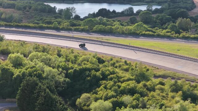 Military Vehicle Driving on a Paved Outdoor Test Track