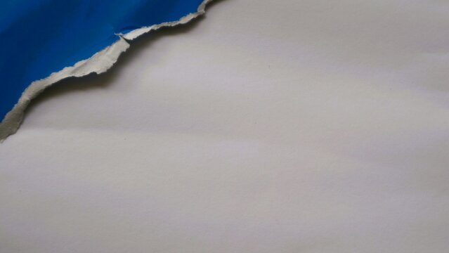 Abstract background with a torn blue paper edge revealing a white surface.
