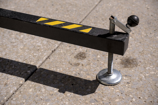 Adjustable threaded leveling foot on a black metal support outrigger. Perfect for structural stability, event staging, and equipment safety concepts.