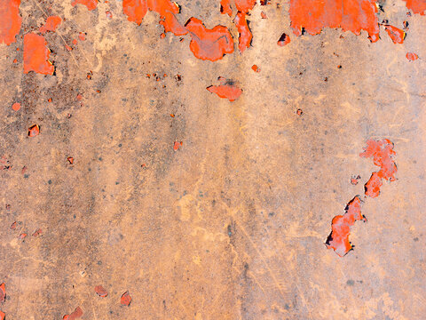 Rusty metal surface featuring distressed orange peeling paint and oxidized rust texture, ideal for industrial background designs, weathered backdrop stock photo image