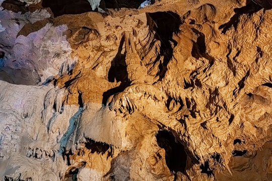 Sinuous rock relief and traces of long-term water flow on a cave wall, Pyrenees, France