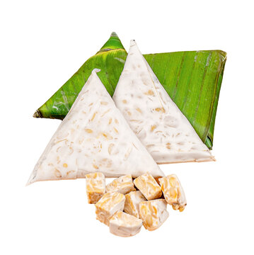Fresh raw triangular tempeh with banana leaf and diced cubes, isolated on transparent background
