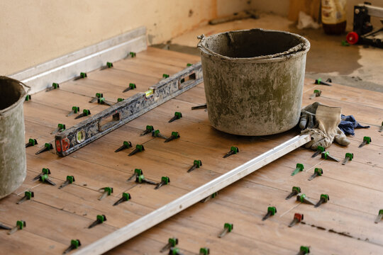 Tile Leveling System Components on The Floor. Closeup, selective focus.