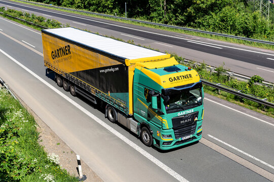 Wiehl, Germany - May 26, 2026: Gartner MAN TGX truck with curtainside trailer on motorway