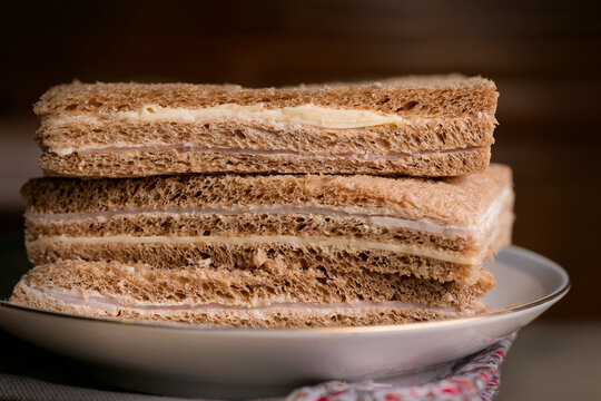 Sandwich de miga argentino stacked on white plate