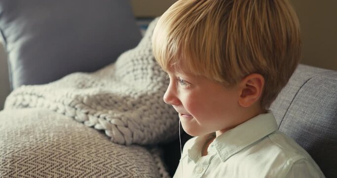Little boy pulling out his first loose tooth