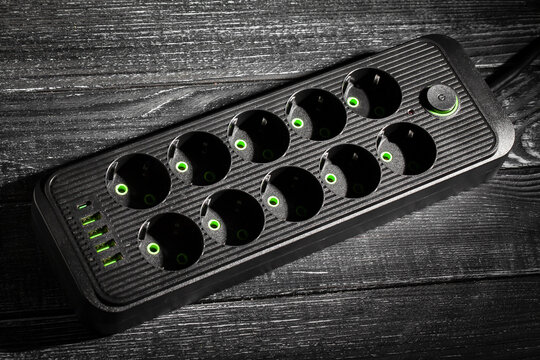 power filter extension cord on black wood background