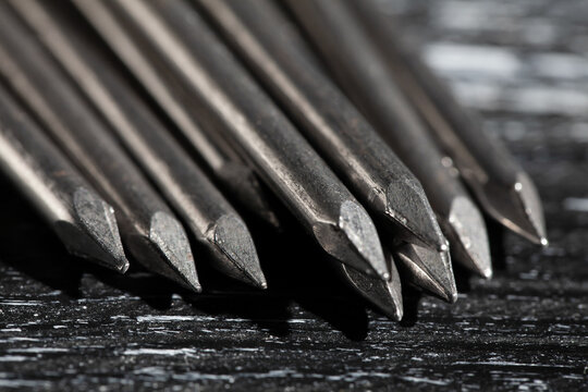 nail tip macro on black wood background