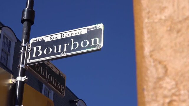 Road sign indicating intersection of bourbon and toulouse streets in historic new orleans quarter.