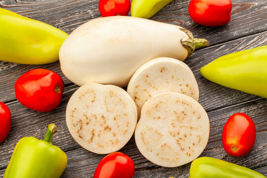 sliced white eggplant on wood background