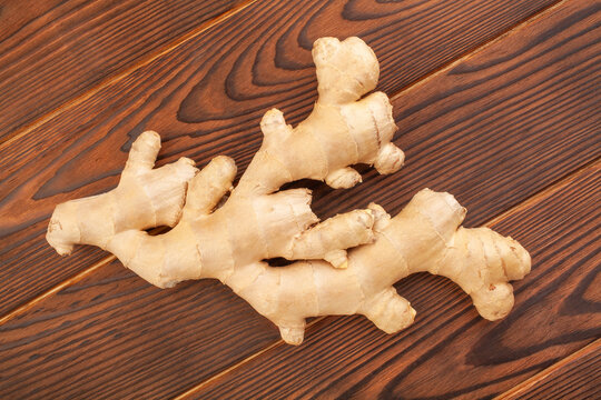 ginger on brown wood background top view