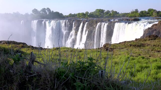 Victoria Falls landscape featuring powerful rushing water and mist cascading over rocky cliffs in southern africa.
