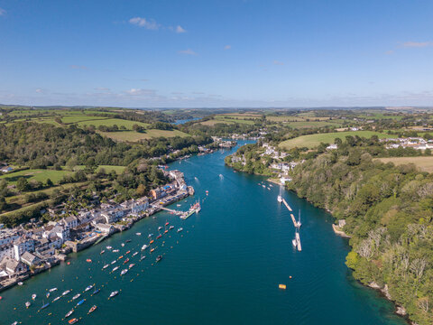Aerial view of Fowey river estuary with moored boats and Cornish countryside