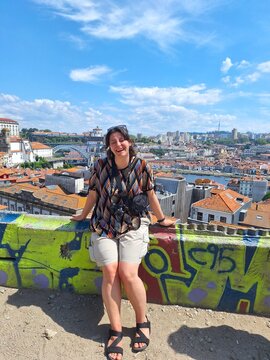Woman enjoying the view of old porto on a sunny day