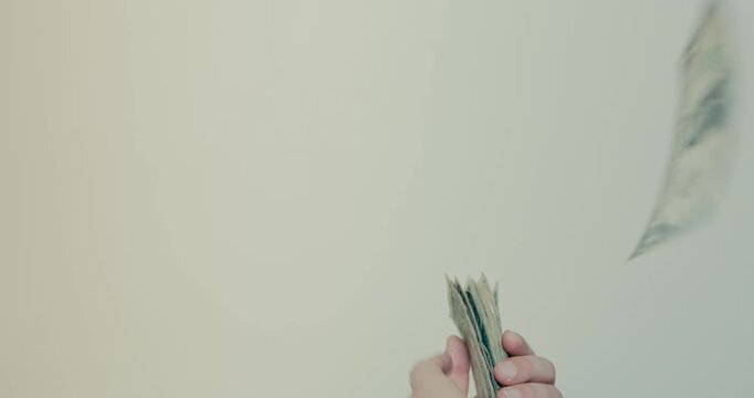 Person throwing and wasting american dollar bills