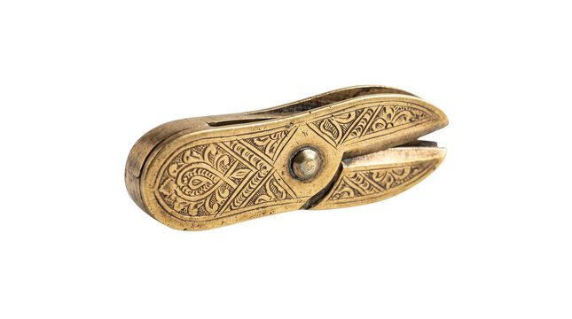 Vintage brass betel nut cutter with ornate engravings, antique bronze slicer tool, traditional metal handicraft on white background
