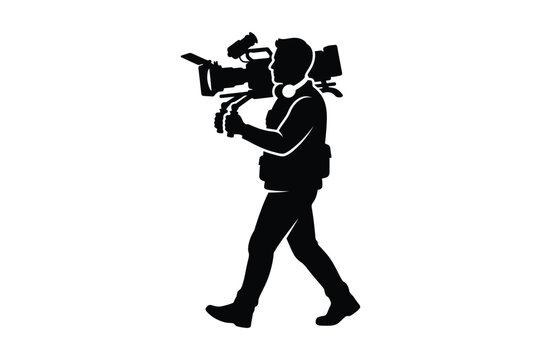 Professional cameraman walking while carrying a large production camera
