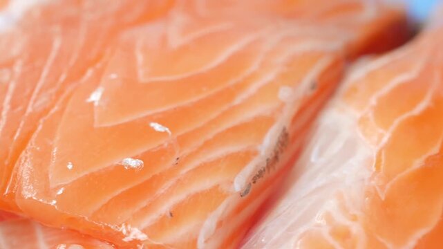 Close-up shot of fresh salmon fillets, vibrant orange and pink color, healthy food preparation, natural texture and patterns