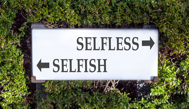 Selfless instead selfish words symbol. Concept words Selfless Selfish on beautiful white sign plate. Beautiful green leaf background. Business medical psychology selfless selfish concept. Copy space.