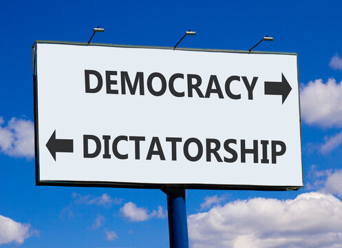 Democracy or dictatorship words symbol. Concept words Democracy Dictatorship on beautiful white billboard. Beautiful blue sky background. Business democracy dictatorship concept. Copy space