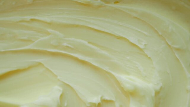 Macro top view of soft creamy yellow butter texture background