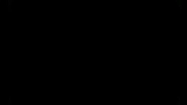 Green glowing light fades away into darkness against an abstract black background