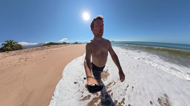 Man Taking a Selfie While Walking Along a Secluded Beach on a Sunny Summer Day in Brazil