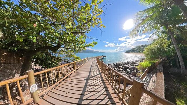 A Paradise Walk Along the Tropical Pier of Feiticeira Beach in Ilhabela, Brazil