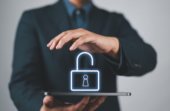 Businessman holding unlock icon symbol.