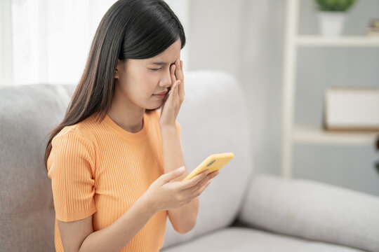 Eye problems, Asian women close eye for relax. eye irritation, eye rubbing, dry, eye pain after read book a long time, migraine, headache, blurred vision, photophobia, small words