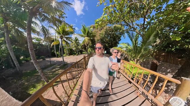 Happy Family Enjoying a Sunny Summer Day at Feiticeira Beach in Ilhabela, Brazil