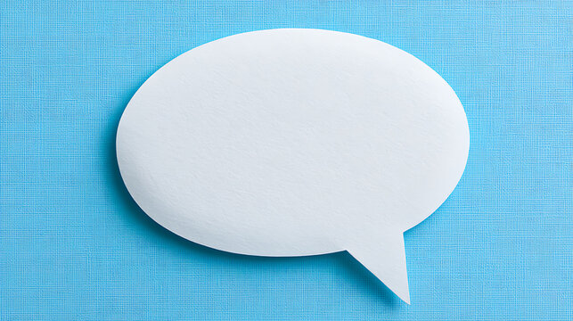 Blank white speech bubble on a textured blue paper background, ideal for communication, dialogue, social media, and chat concepts