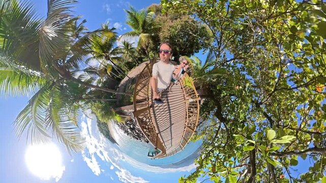 Mini Planet 360 View of a Happy Family Walking Along the Pier at Feiticeira Beach, Ilhabela, Brazil