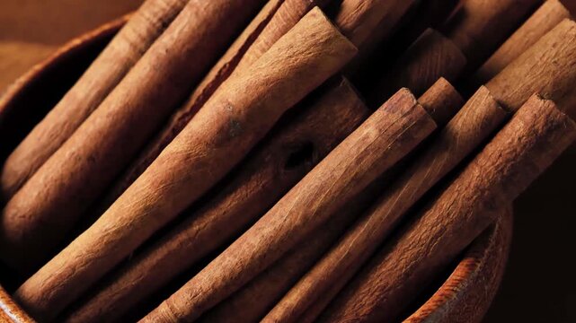 Dried Cinnamon Sticks Spinning in a Wooden Bowl	