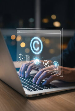Close up of person typing on laptop with copyright icon and legal symbols interface