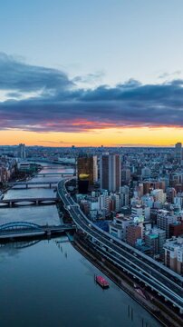  Vertical video, 4k Time lapse Aerial view of Tokyo metropolis and sunrise over the city skyline.