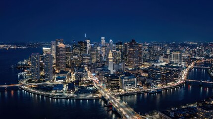 Fototapeta premium Panoramic Nighttime Aerial View of a Vibrant City Skyline Illuminated by City Lights.