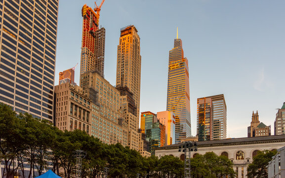 New York City skyscrapers illuminated by sunset light viewed from Bryant Park