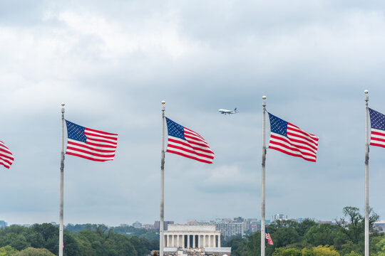 American flags with Lincoln Memorial and airliner in Washington DC