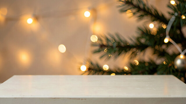 Golden hour empty a pale limewashed wood table as a holiday display with festive lights