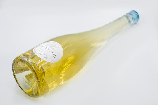 Blanc La Baume Languedoc French wine bottle closeup on white.