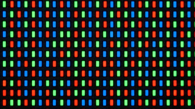 Microscopic close up view of a smartphone screen OLED pixel matrix glowing red green blue subpixels
