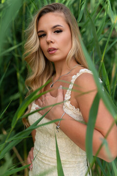 Young woman posing in tall green grass