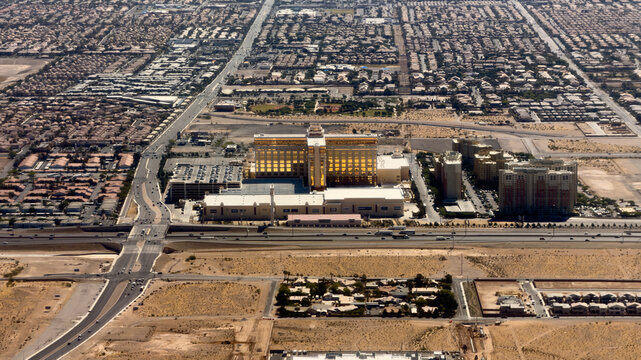 LAS VEGAS, NV, APR 28, 2026: Aerial view of a Las Vegas suburb featuring a large casino resort, apartment towers, and a busy freeway interchange