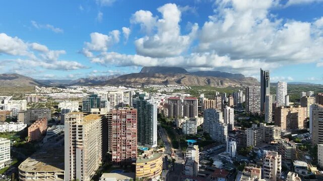 Aerial 360-degree panorama over the Poniente district of Benidorm, revealing high-rise skyscrapers, the coastline and the Mediterranean Sea, Costa Blanca, Alicante, Spain, morning.