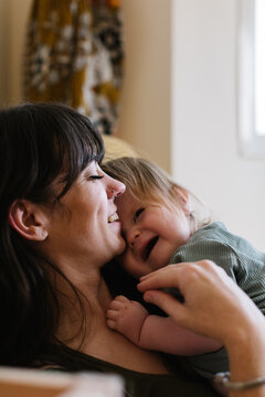 Close-up of a laughing mother and baby.