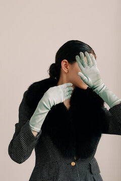 Expressive fashion portrait with satin gloves and fur collar