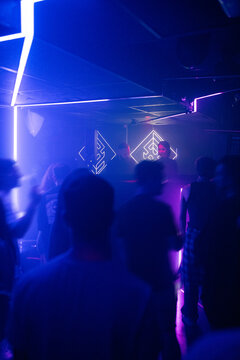 People Dancing and Enjoying Time at a Club With Neon Lights