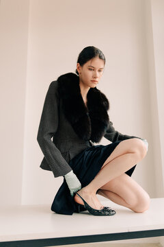 Sophisticated seated fashion portrait in tailored vintage styling